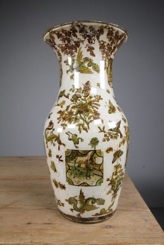 A 19th-century baluster-shaped glass vase featuring internal decalcomania imagery of figures, birds, and floral patterns against a cream background. View IX