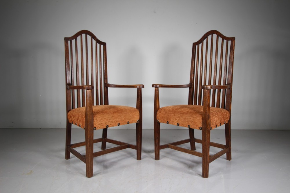 Set of six solid oak Arts and Crafts dining chairs featuring tall spindled backs and terracotta fabric upholstered seats. View IV