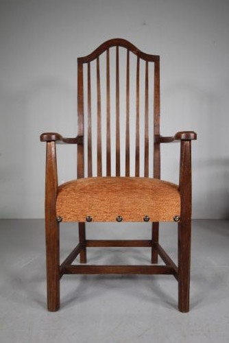 Set of six solid oak Arts and Crafts dining chairs featuring tall spindled backs and terracotta fabric upholstered seats. View V