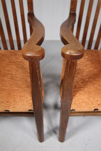 Set of six solid oak Arts and Crafts dining chairs featuring tall spindled backs and terracotta fabric upholstered seats. View VIII