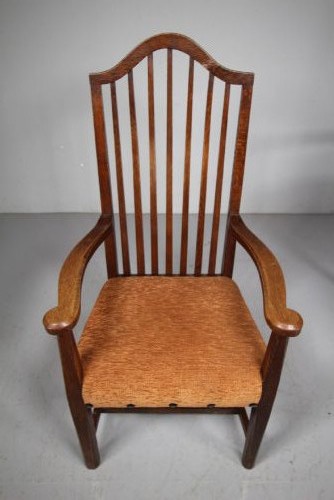 Set of six solid oak Arts and Crafts dining chairs featuring tall spindled backs and terracotta fabric upholstered seats. View VII