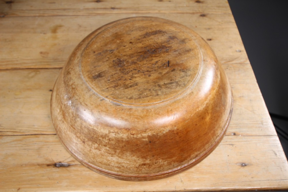 A large 19th-century turned sycamore wooden dairy bowl showing natural grain patina and turned rim detail. View III