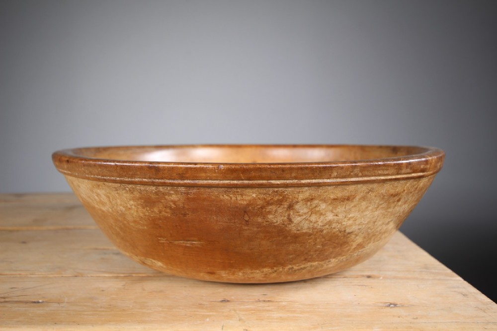 A large 19th-century turned sycamore wooden dairy bowl showing natural grain patina and turned rim detail. View IV
