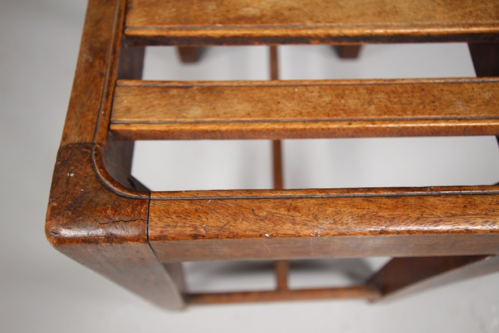 An English Georgian mahogany stool featuring a concave slatted seat, square tapered legs, and a low H-stretcher frame. View III