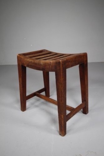 An English Georgian mahogany stool featuring a concave slatted seat, square tapered legs, and a low H-stretcher frame. View VI