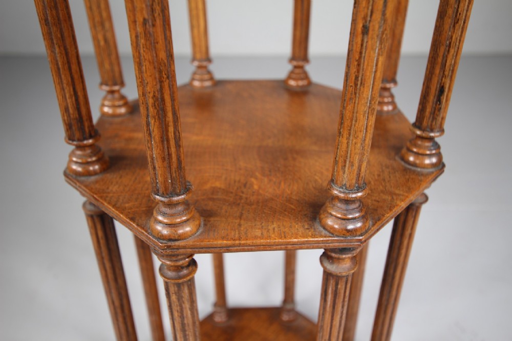 An English 19th-century oak library scroll stand featuring an octagonal structure supported by fluted vertical columns with turned finials. View II
