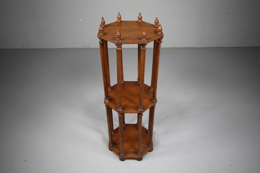 An English 19th-century oak library scroll stand featuring an octagonal structure supported by fluted vertical columns with turned finials. View IV