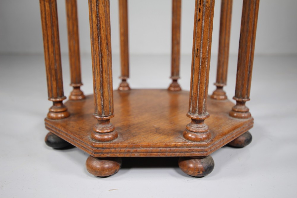 An English 19th-century oak library scroll stand featuring an octagonal structure supported by fluted vertical columns with turned finials. View V