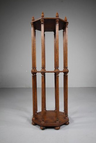 An English 19th-century oak library scroll stand featuring an octagonal structure supported by fluted vertical columns with turned finials.