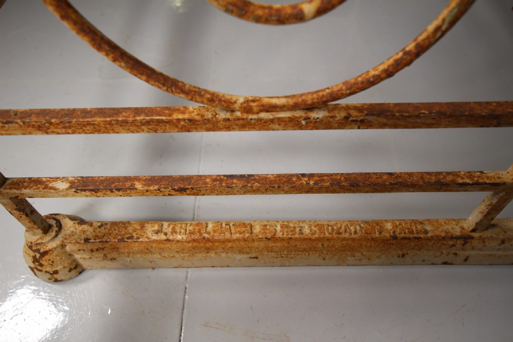 A tall 19th-century French bakers rack constructed from wrought iron with brass-rimmed shelves and scrollwork details. View IV