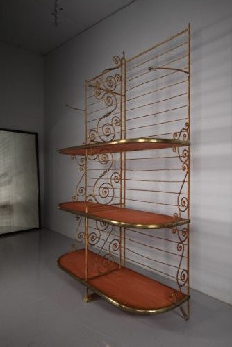A tall 19th-century French bakers rack constructed from wrought iron with brass-rimmed shelves and scrollwork details. View V