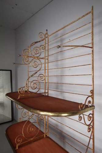A tall 19th-century French bakers rack constructed from wrought iron with brass-rimmed shelves and scrollwork details. View VI