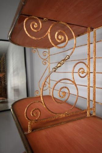 A tall 19th-century French bakers rack constructed from wrought iron with brass-rimmed shelves and scrollwork details. View IX