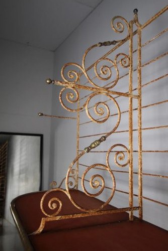 A tall 19th-century French bakers rack constructed from wrought iron with brass-rimmed shelves and scrollwork details. View VII
