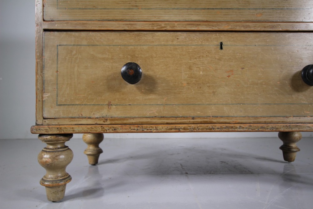 A Regency original painted pine chest of drawers featuring two short over two long drawers, turned legs, dark knobs, and hand-painted border lines. View IV