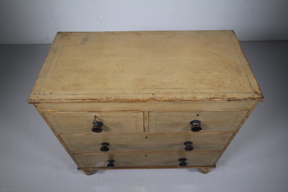 A Regency original painted pine chest of drawers featuring two short over two long drawers, turned legs, dark knobs, and hand-painted border lines. View VI