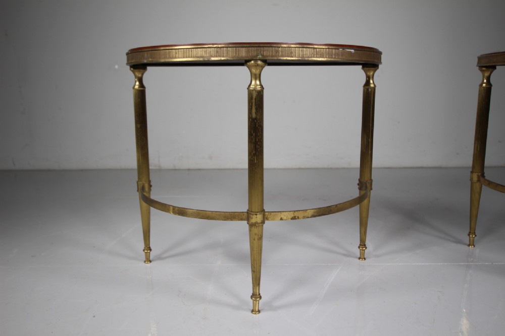 A pair of 1930s semi-circular brass side tables featuring fluted tapering legs, curved stretchers, and reeded edge aprons. View V