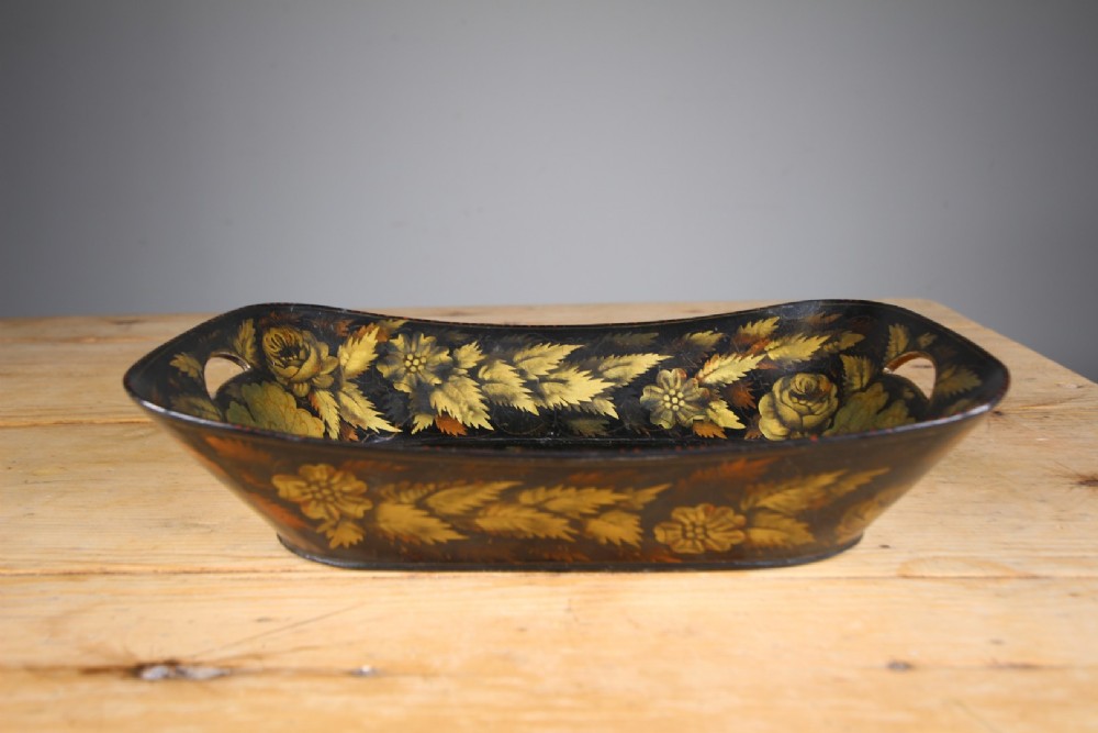 An antique black lacquered papier-mache tray featuring hand-painted gold floral borders and integrated side handles. View IV