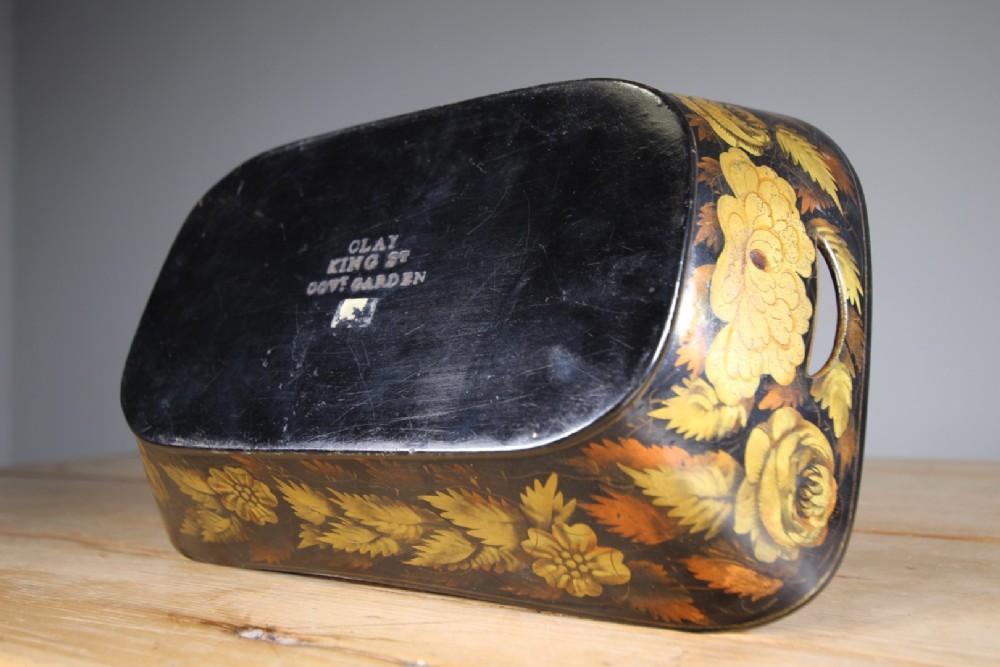 An antique black lacquered papier-mache tray featuring hand-painted gold floral borders and integrated side handles. View V