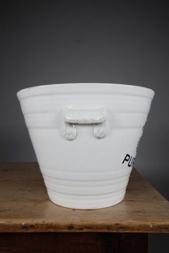 A white glazed ironstone dairy pail featuring integrated side handles, horizontal ribbed detailing, and a black transferware illustration of cows above the text PURE MILK. View III