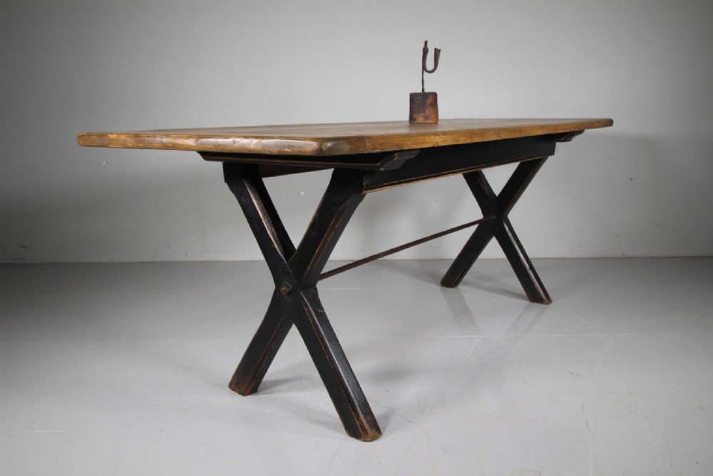 A 19th-century oak tavern dining table featuring a natural timber top, a black painted X-frame trestle base, and a central iron stretcher. View II