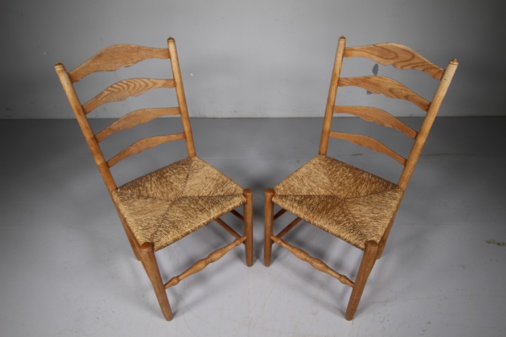A pair of 1920s Arts and Crafts oak side chairs with ladderback frames and woven rush seats. View III