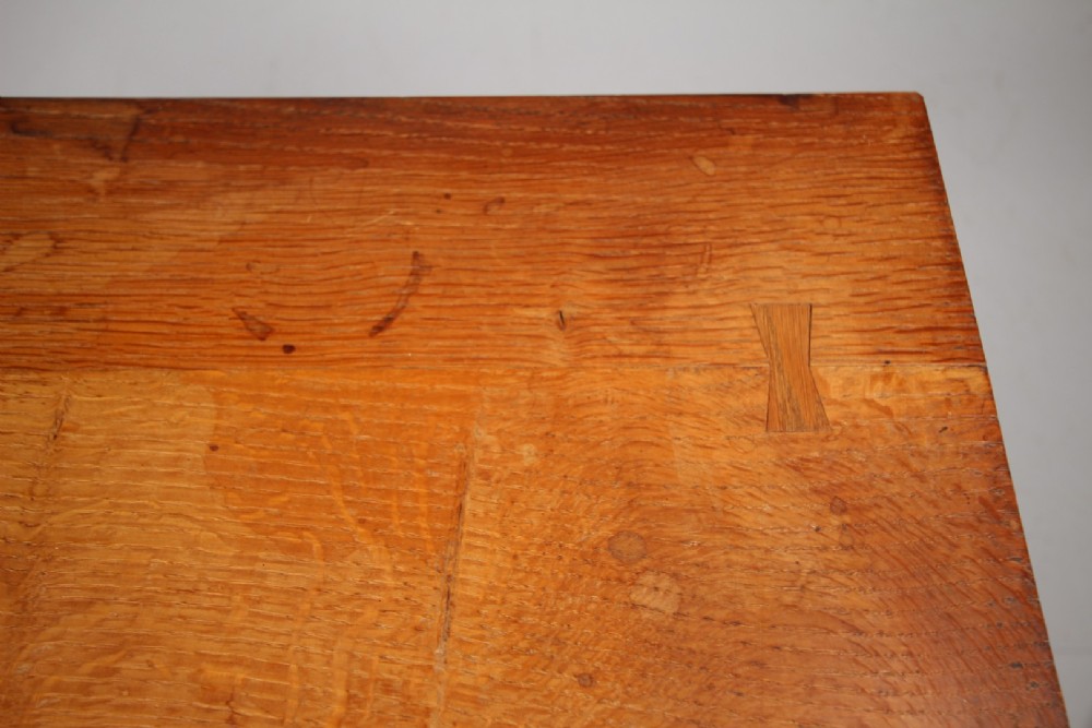 A solid oak two-door cupboard featuring recessed square door panels, carved wooden handles, and four square straight legs. View II