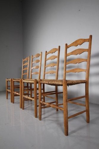 A set of four vintage Arts and Crafts ladderback dining chairs featuring natural woven rush seats and turned timber stretchers. View VI