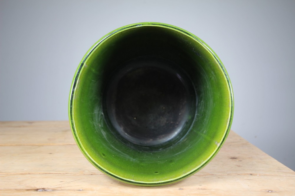 A large cylindrical Victorian Burmantofts ceramic plant pot featuring a rich green glaze and subtle horizontal moulded banding around the rim and base. View III