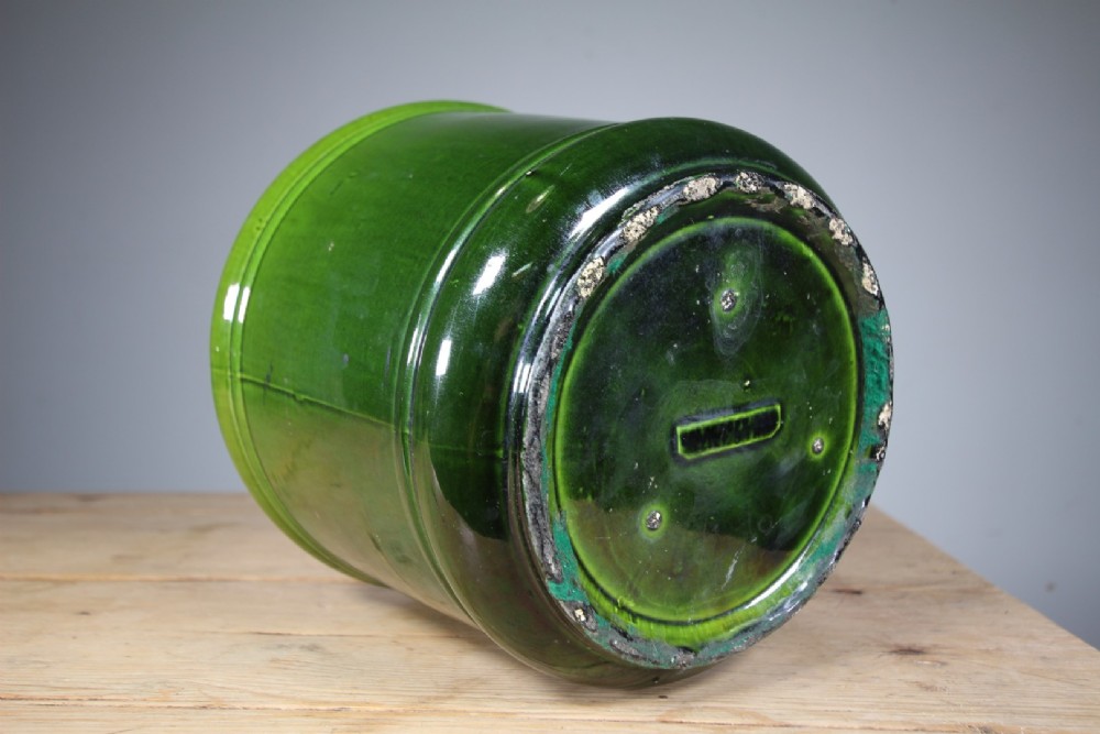 A large cylindrical Victorian Burmantofts ceramic plant pot featuring a rich green glaze and subtle horizontal moulded banding around the rim and base. View IV
