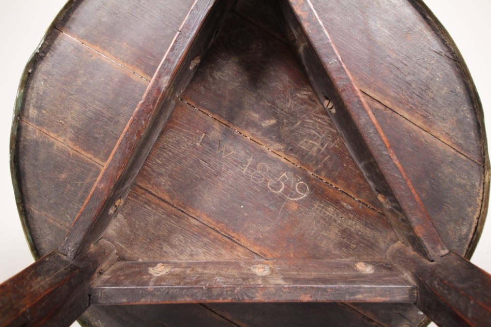 A nineteenth-century dark oak three-legged cricket table featuring a circular top bound with a studded brass rim and supported by a triangular stretcher. View VIII