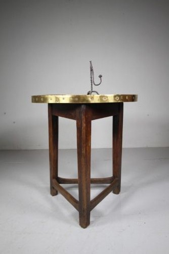 A nineteenth-century dark oak three-legged cricket table featuring a circular top bound with a studded brass rim and supported by a triangular stretcher. View IV