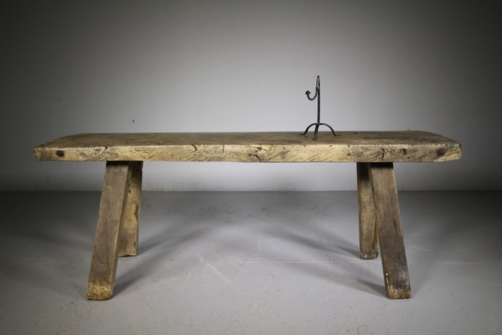 A low, thick-topped Georgian oak pig bench with four rustic splayed legs displaying a natural weathered finish. View III