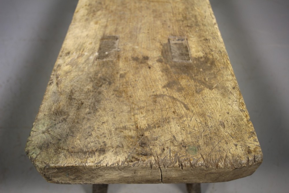 A low, thick-topped Georgian oak pig bench with four rustic splayed legs displaying a natural weathered finish. View VI