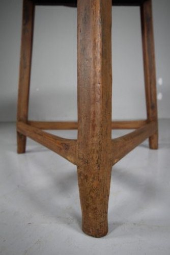 An 18th-century painted pine cricket table featuring a circular wooden top supported by three legs and triangular lower stretchers. View III