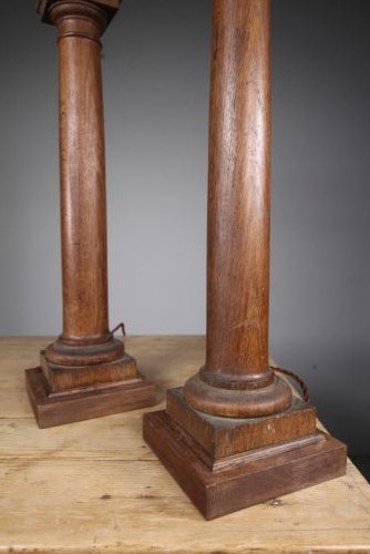A pair of tall antique Edwardian oak table lamps carved in the form of classical architectural columns with square stepped bases and brass bulb sockets. View II