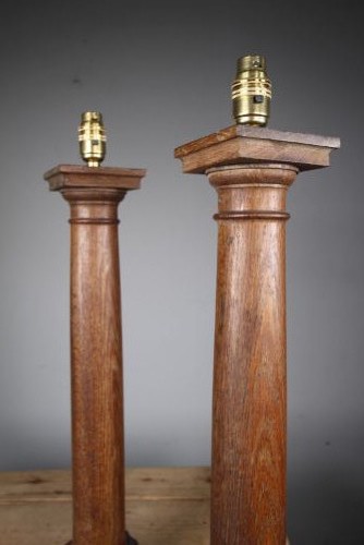 A pair of tall antique Edwardian oak table lamps carved in the form of classical architectural columns with square stepped bases and brass bulb sockets. View IV