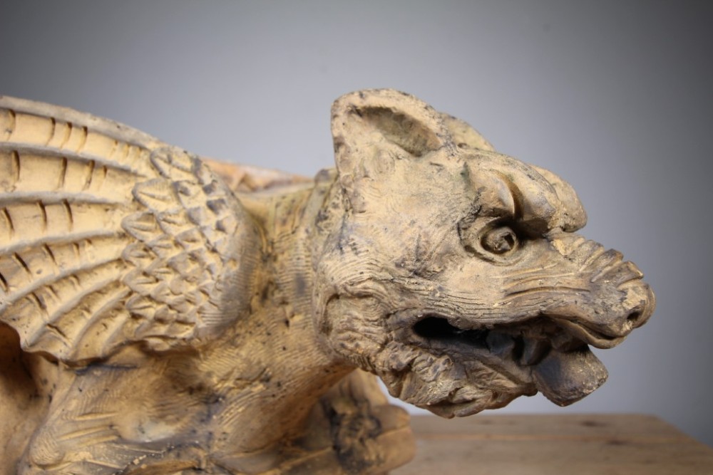 A nineteenth-century weathered buff terracotta gargoyle corbel featuring a winged beast with open jaws. View III