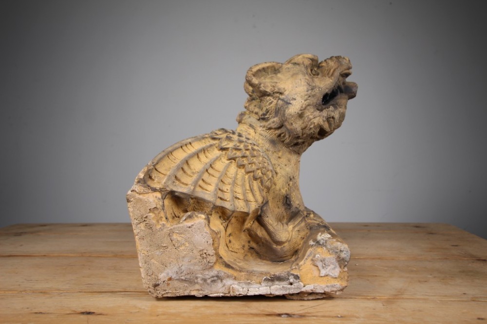 A nineteenth-century weathered buff terracotta gargoyle corbel featuring a winged beast with open jaws. View IV