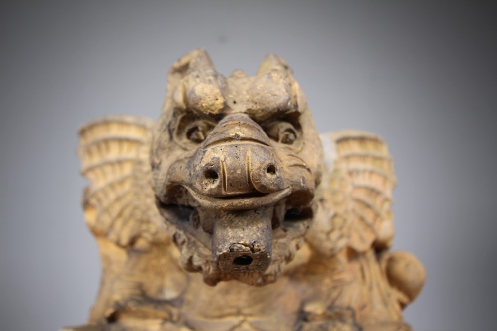 A nineteenth-century weathered buff terracotta gargoyle corbel featuring a winged beast with open jaws. View VIII