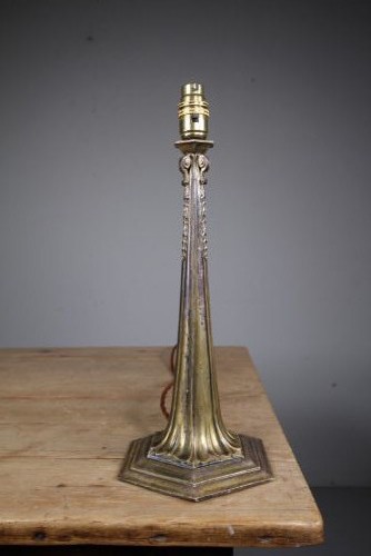 A tall antique silver-plated table lamp featuring a fluted column, classical foliate capital, and a stepped hexagonal base. View V