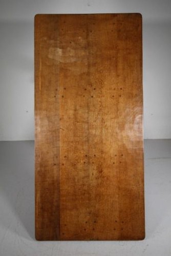 An English Arts and Crafts adzed oak refectory dining table featuring octagonal pedestal legs connected by a floor stretcher, displaying a carved mouse signature. View VI
