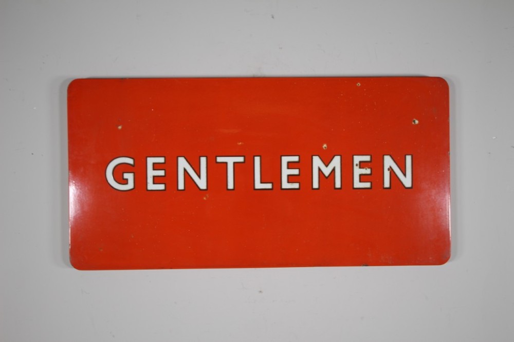 A rectangular red vitreous enamel railway sign featuring the word GENTLEMEN in bold white capital letters with black outlines.
