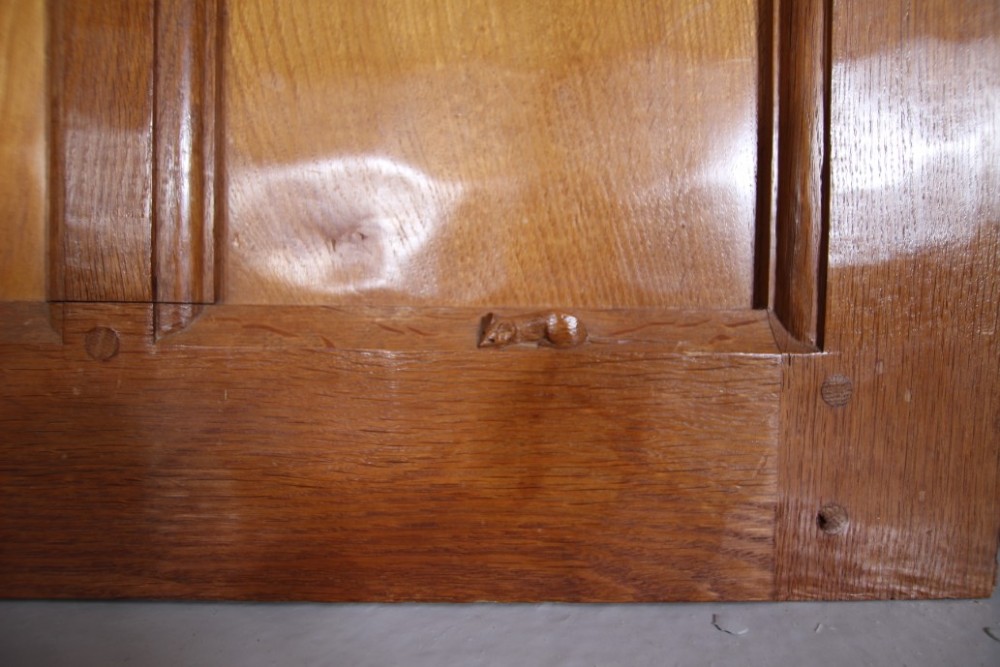 A solid oak interior door featuring ten raised panels, a hand-adzed textured finish, wrought iron latch hardware, and a carved mouse detail. View II
