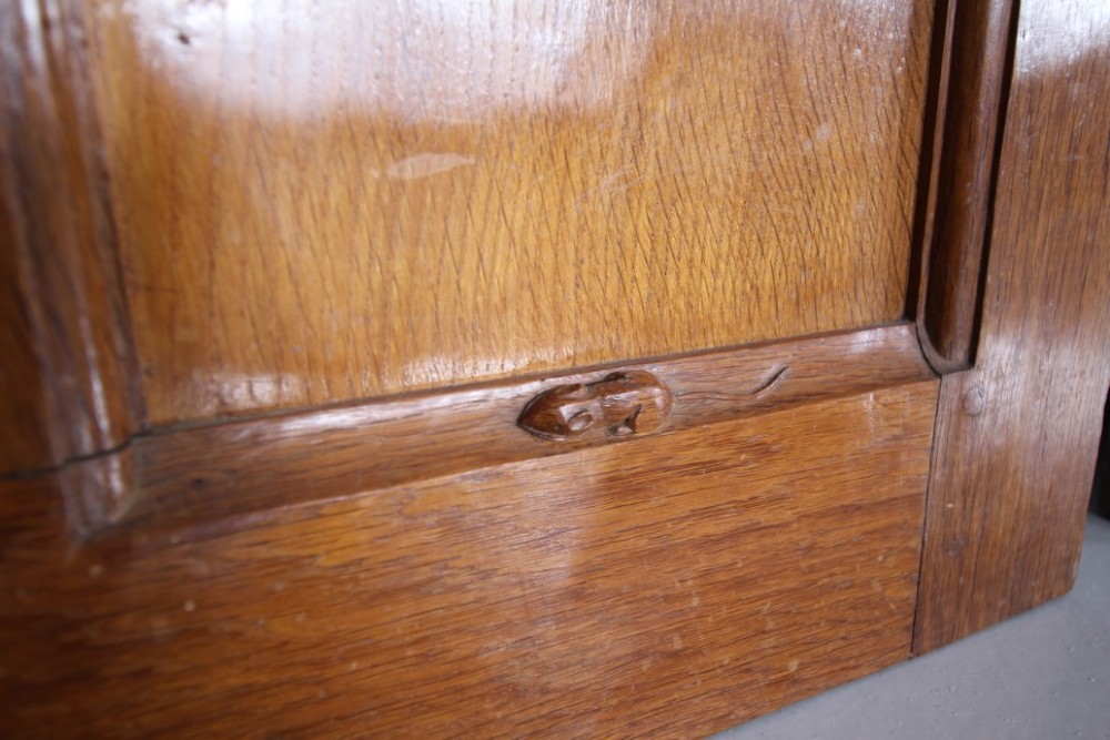 A solid oak interior door featuring ten raised panels, a hand-adzed textured finish, wrought iron latch hardware, and a carved mouse detail. View XIII