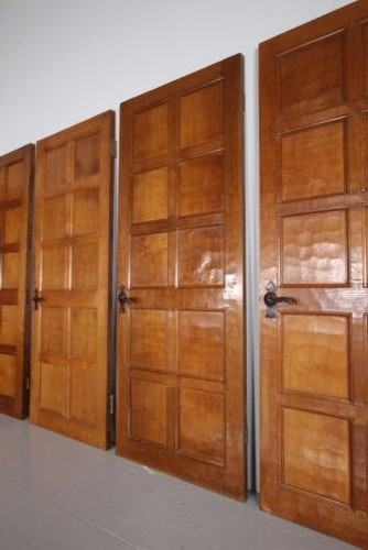 A solid oak interior door featuring ten raised panels, a hand-adzed textured finish, wrought iron latch hardware, and a carved mouse detail. View VIII