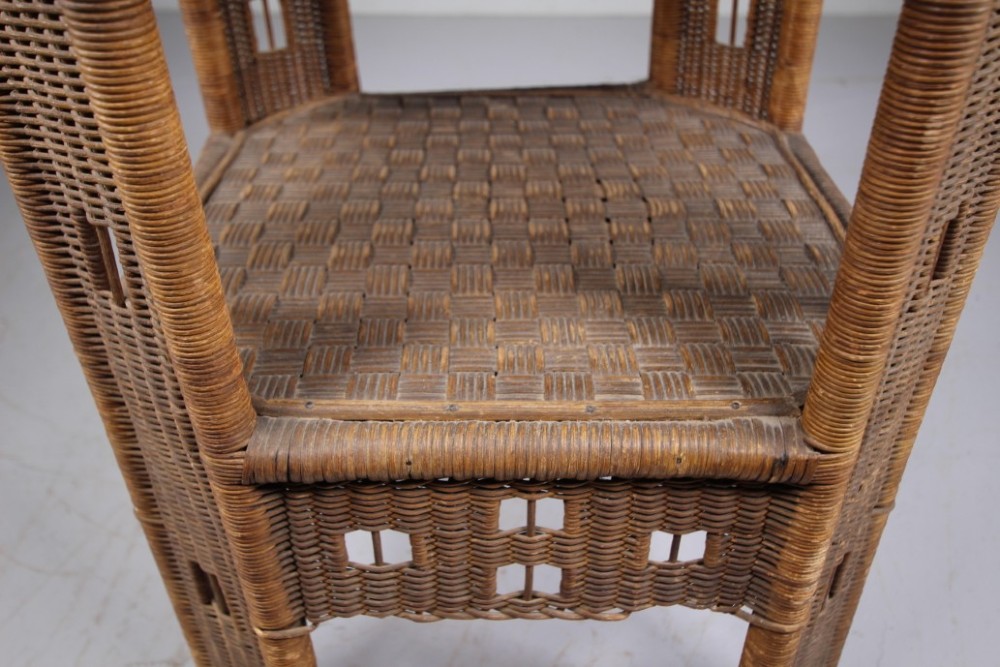 A 1920s English woven wicker side table featuring geometric openwork weave and a broad top on woven legs. View II