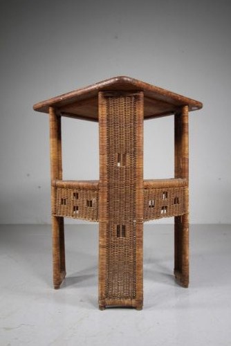 A 1920s English woven wicker side table featuring geometric openwork weave and a broad top on woven legs. View V