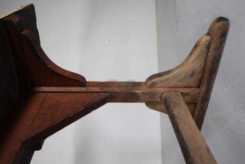 An English nineteenth-century trestle tavern dining table featuring a scrubbed natural timber top and a distressed red-painted base with a stretcher. View IV