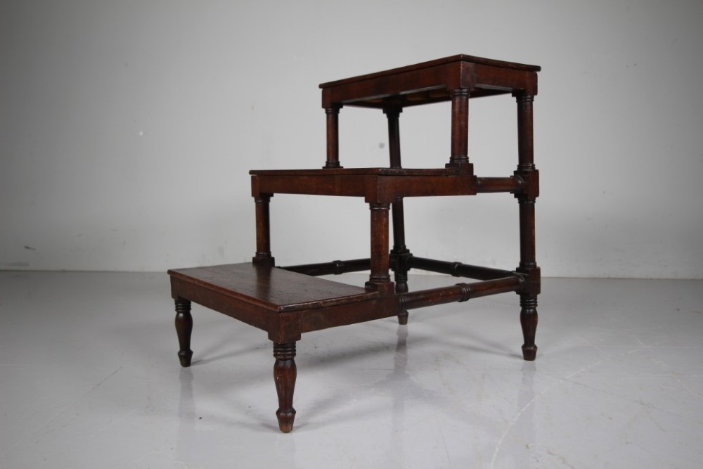 A three-tiered set of 19th-century dark mahogany library steps featuring turned legs and supporting stretchers. View II